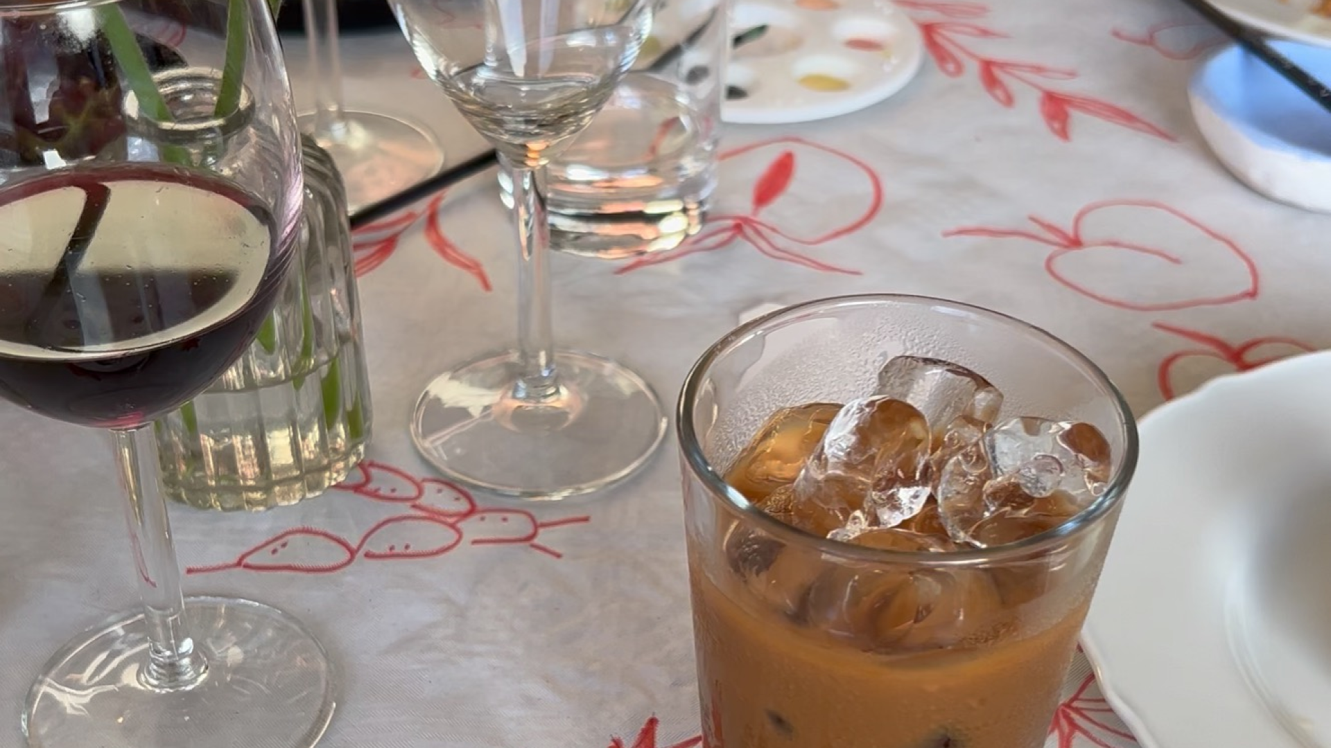 A wine glass beside a coffee cup, comparing wine and coffee tasting